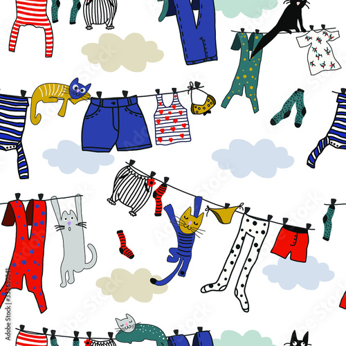 Hand drawn vector cute cartoon seamless pattern illustration colorful clothes on the rope and sleeping cats on white background.