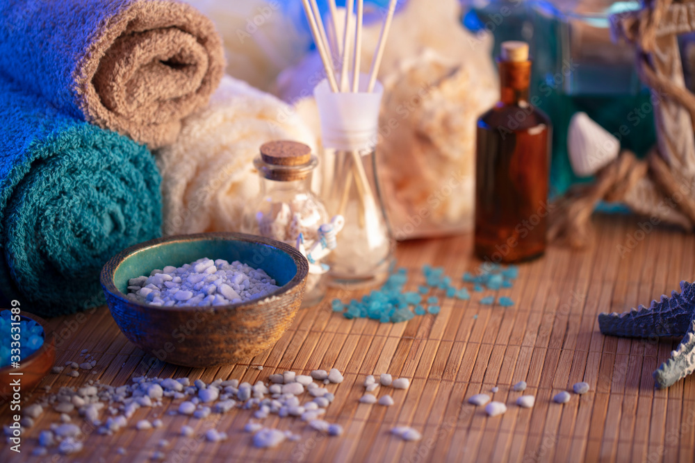 Spa and wellness concept. Bottles with cosmetics, bath salts and care products on wooden paneling. Spa and wellness concept. Bottles with cosmetics, bath salts and care products on wooden paneling.