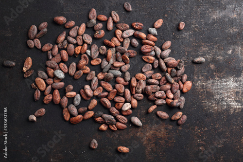 Cocoa Beans. Organic cocoa beans on a dark background. Background with cocoa beans.