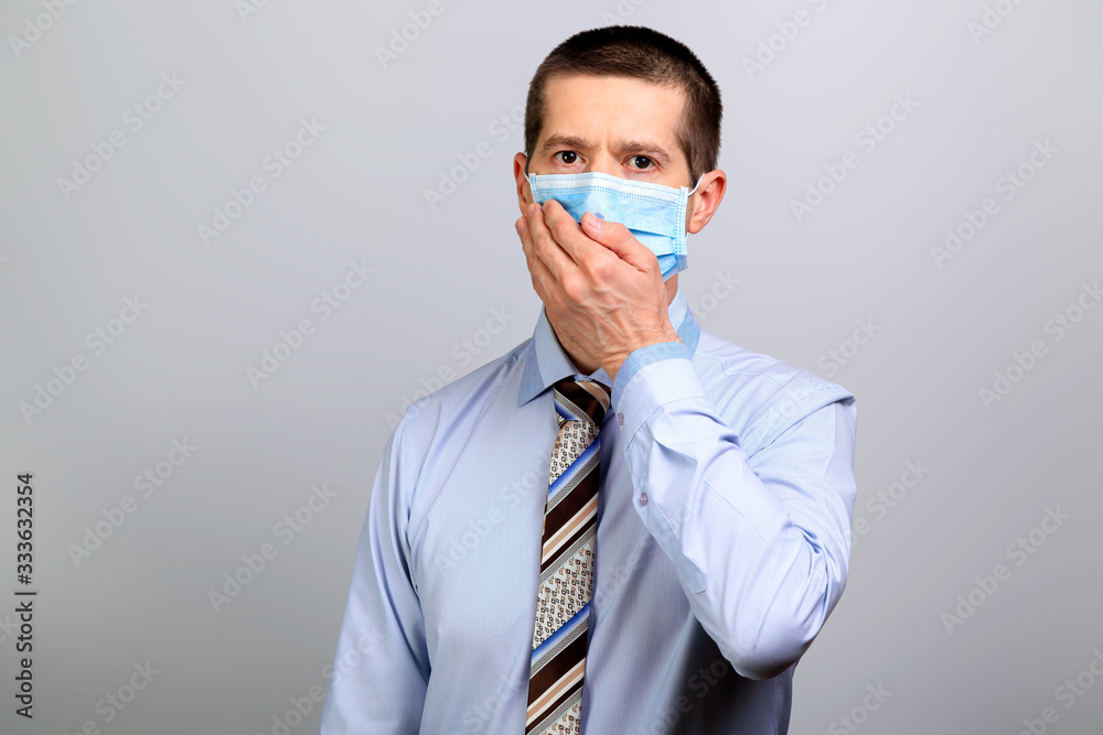 Business man in medical mask covered his mouth with his hand