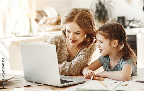 Wallpaper Mural Happy girl with mother studying online at home. Torontodigital.ca