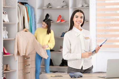 Female seller in modern clo...