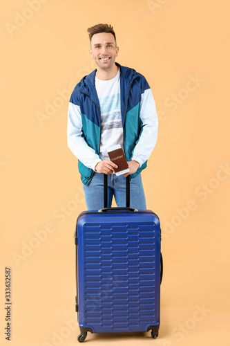 Male tourist with luggage o...