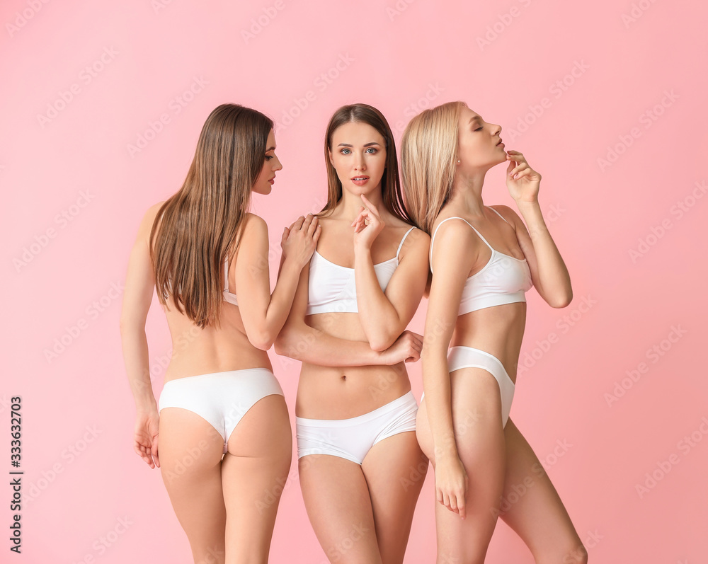 Foto de Beautiful young women in underwear on color background do