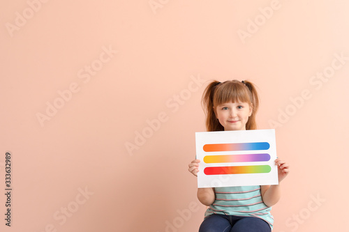 Little girl with color palettes on pink background