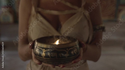 A monk in an ancient temple lights a sacred fire, the priestess brought him the holy grail, the Indian temple of Maharaja