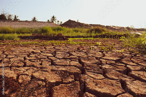 Dry cracked earth background in arid season. Many Province of North East in Thailand the ground dry. Brown cracked soil in the summer When water in Mekong dry up.