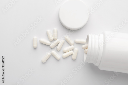 Jar with pills on white background