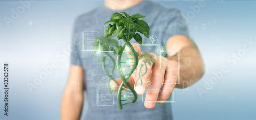 Businessman holding a DNA growing as a plant - 3d rendering