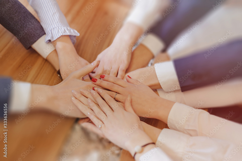 many hands of people in suits and shirts in the middle of the table, the work of the team many hands of people in suits and shirts in the middle of the table, the work of the team