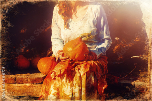 Woman holding hokaido pumpkin in organic permaculture garden, old photo effect photo