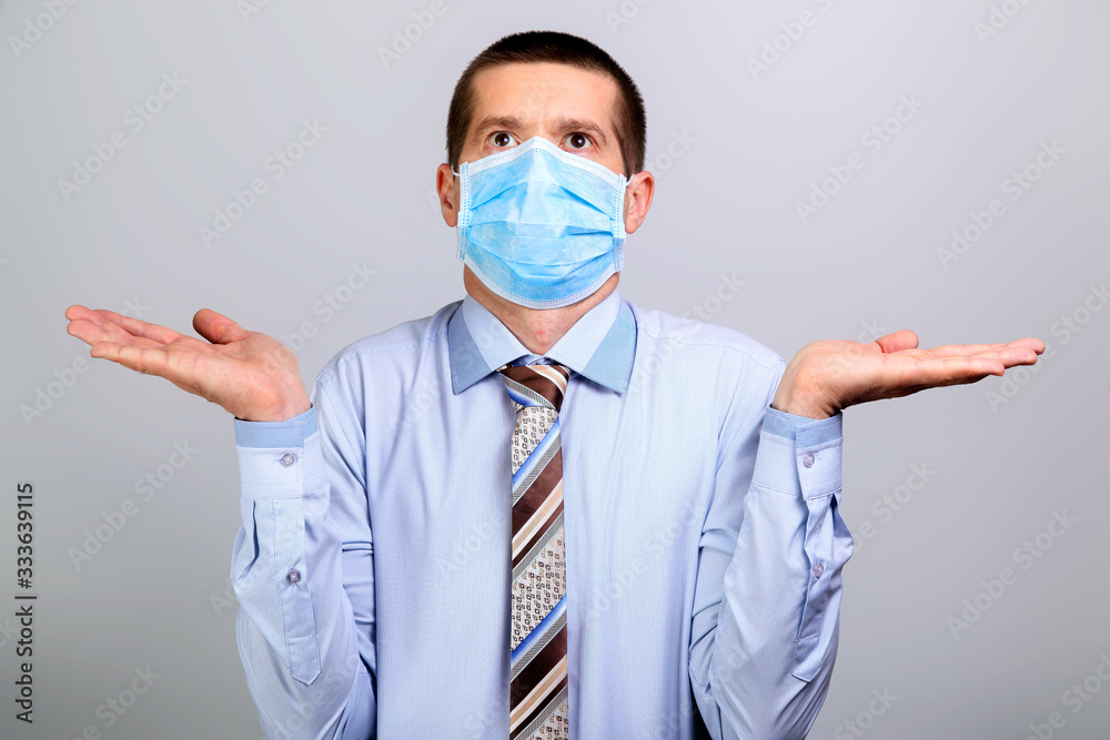 A business man in a mask spins his hands in the sides and looks up A business man in a mask spins his hands in the sides and looks up