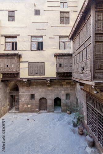 Facade of ottoman era historic house of Zeinab Khatoun with wooden oriel windows - Mashrabiya - located at Azhar district, Medieval Cairo, Egypt photo