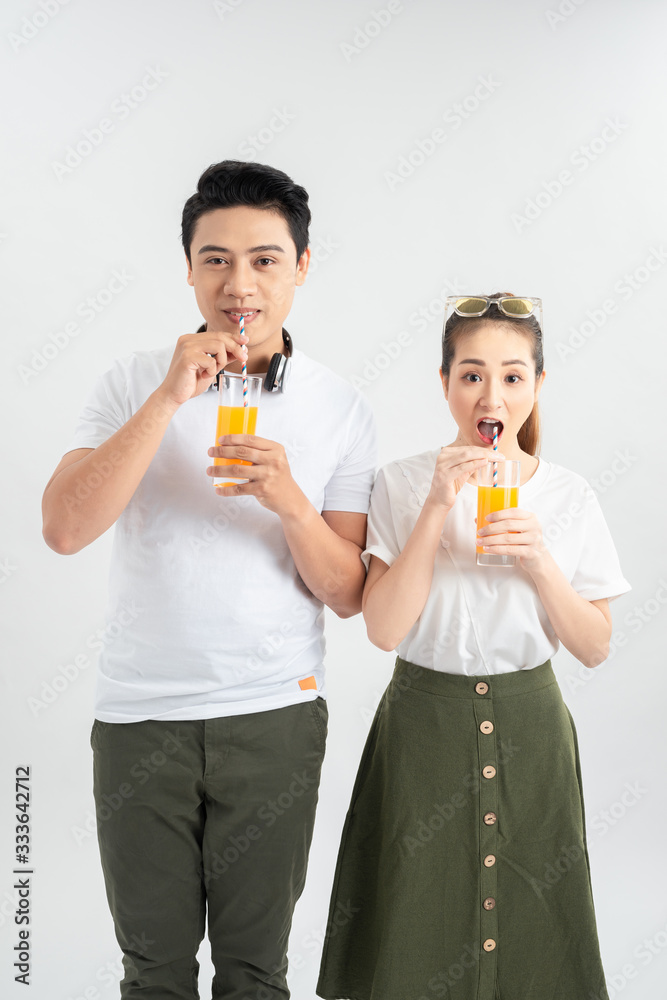 love, family, healthy food and happiness concept - smiling happy couple drinking juice on white background love, family, healthy food and happiness concept - smiling happy couple drinking juice on white background