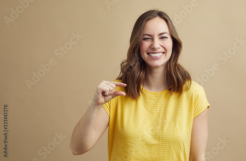 Fényképezés beautiful girl giggles and shows how small it was concept