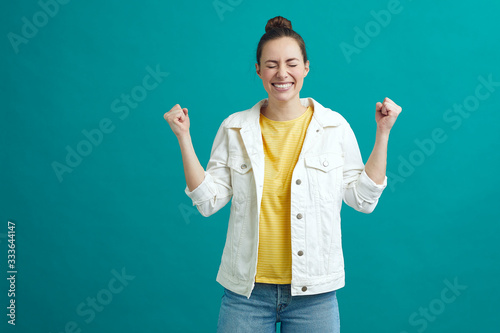 Excited happy girl holding her hands up celebrating © Martin Villadsen