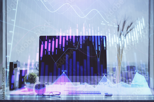 Stock market chart hologram drawn on personal computer background. Double exposure. Concept of investment. © peshkova