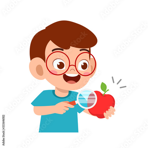happy cute little kid boy holding magnifying glass