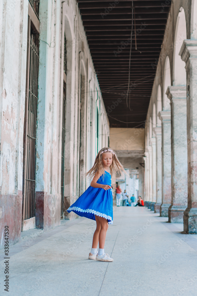 Tourist girl in popular area in Havana, Cuba. Young kid traveler smiling