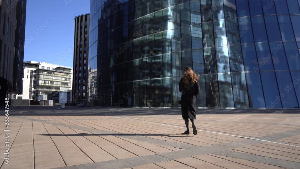 Young Business Woman Goes In The Office Building. View from the back Young Business Woman Goes In The Office Building. View from the back