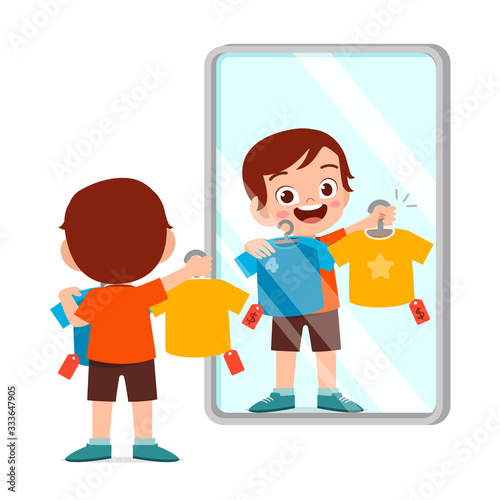 happy cute little kid boy choose a clothes