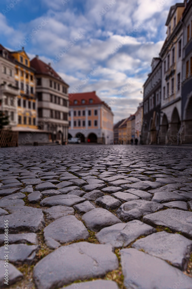 Lower Market Square (Ubermarkt) of Goerlitz Germany with old houses, arcades, stone paving. Selecrive focus, blurred background.