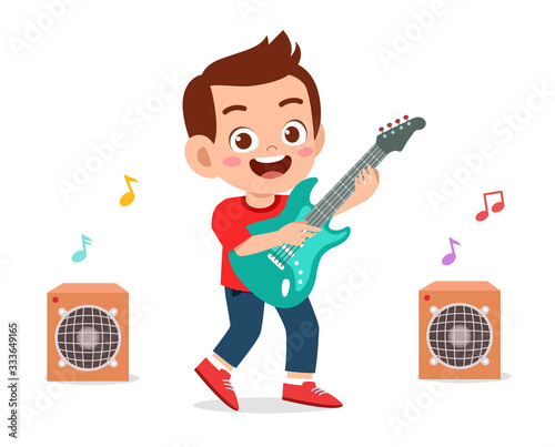 happy cute little kid boy play guitar