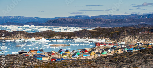 View from a nearby hill, overlooking the town of Illulisat, West Greenland . photo