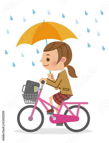 自転車で傘差し運転をする女子生徒