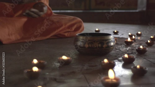 A monk in an ancient temple lights a sacred fire, the priestess brought him the holy grail, the Indian temple of Maharaja