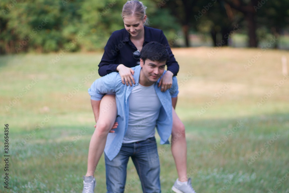European couples, men and women Showing love to each other in the garden. During the holidays, warm and comfortable holidays in the fields and large trees. Who are planning a marriage European couples, men and women Showing love to each other in the garden. During the holidays, warm and comfortable holidays in the fields and large trees. Who are planning a marriage