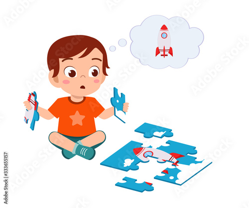 happy cute little kid boy play jigsaw puzzle