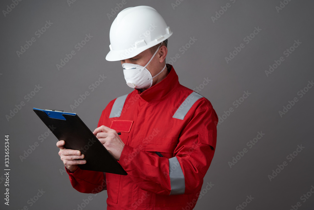 Man engineer, construction worker wearing face mask Man engineer, construction worker wearing face mask