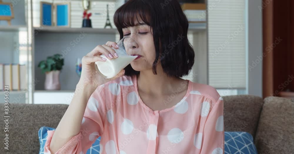Asian pretty young woman drink milk with happy Asian pretty young woman drink milk with happy