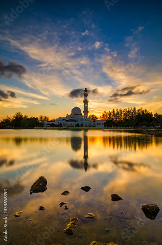 Beautiful floating mosque located in Kuala Ibai, Terengganu Malaysia over stunning sunset background photo