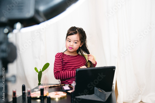 Asian Child Make up Beauty blogger showing how to make up Video Tablet , Happy Asian girl vlogger recording video