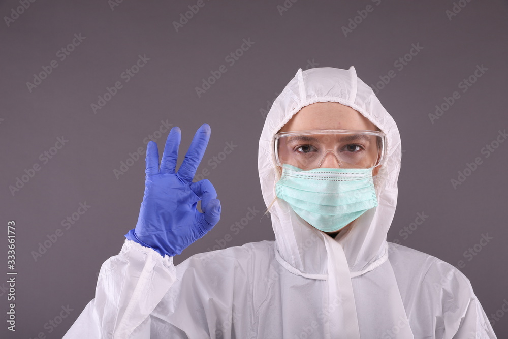 Woman in protective costume shows ok sign Woman in protective costume shows ok sign