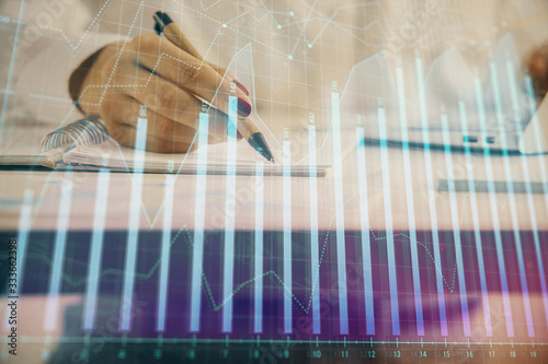 Wallpaper Mural Double exposure of woman's hands making notes with forex graph hologram. Concept technical analysis. Torontodigital.ca