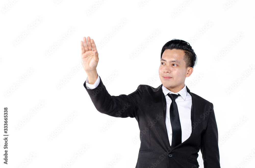 Young business man wearing black suit using finger on augmented reality touch screen against white background Young business man wearing black suit using finger on augmented reality touch screen against white background