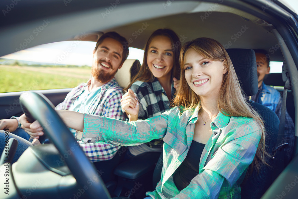 A group of happy friends are driving in a car. A group of happy friends are driving in a car.