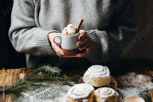 Canvas-taulu Woman's hands holding hot cocoa with whipped cream and cinnamon stick, Christmas