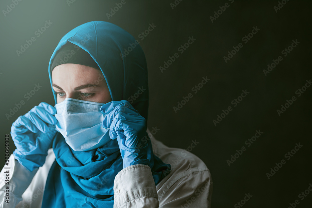 a doctor, a Muslim woman in a hijab and a protective medical bandage, was tired after taking a large number of patients as a result of the outbreak of the coronavirus