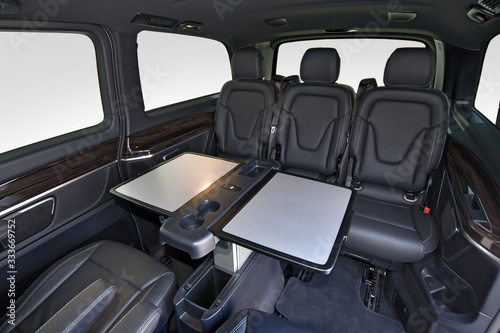 Fotografie Interior of luxury van with comfortable leather seats and table