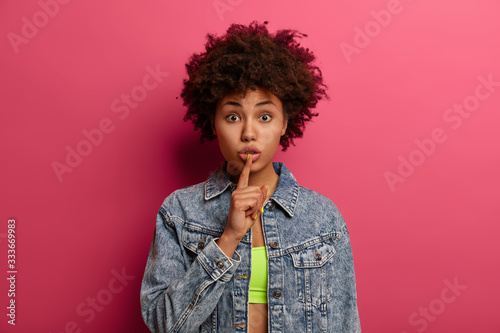 Fotografija Photo of mysterious dark skinned woman prepares special surprise for you, makes