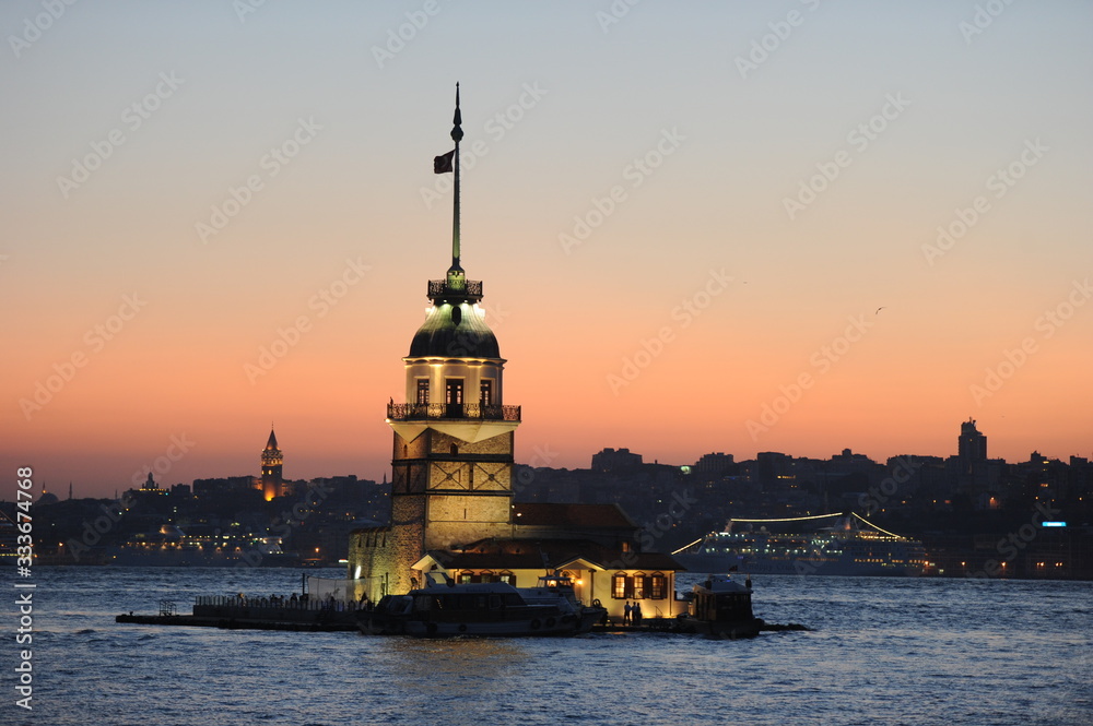 Fiery sunset over Bosphorus with famous Maiden's Tower (Kiz Kulesi) also known as Leander's Tower, symbol of Istanbul, Turkey. Scenic travel background for wallpaper or guide book