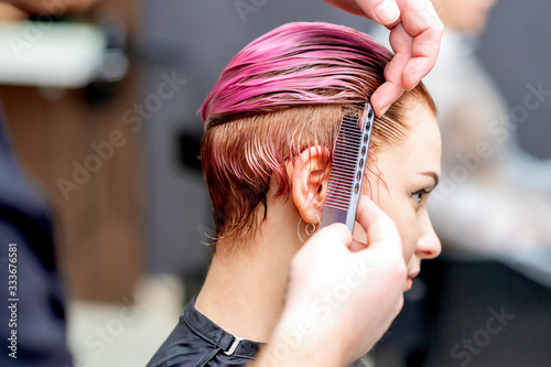 Wallpaper Mural Hairdresser combs hair.