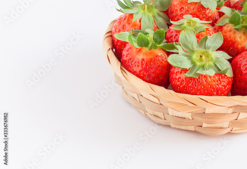 Strawberries in ecological wooden packaging on a white background with copy space. Red berries. Natural vitamins.