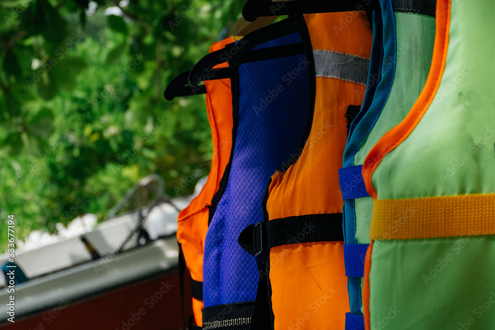 Close-up group of Life jacket or life vest hanging under the shelter at Pangkor Island, Malaysia
