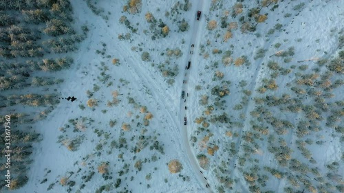 Aerial Drone Shot Of Tourist Group In Husky ride In Lapland Rovaniemi Finland Birds Eye View photo