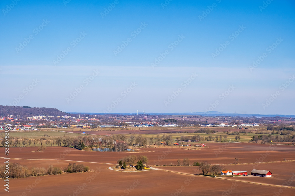 Aerial view of rural landscape in spring with a city in the background